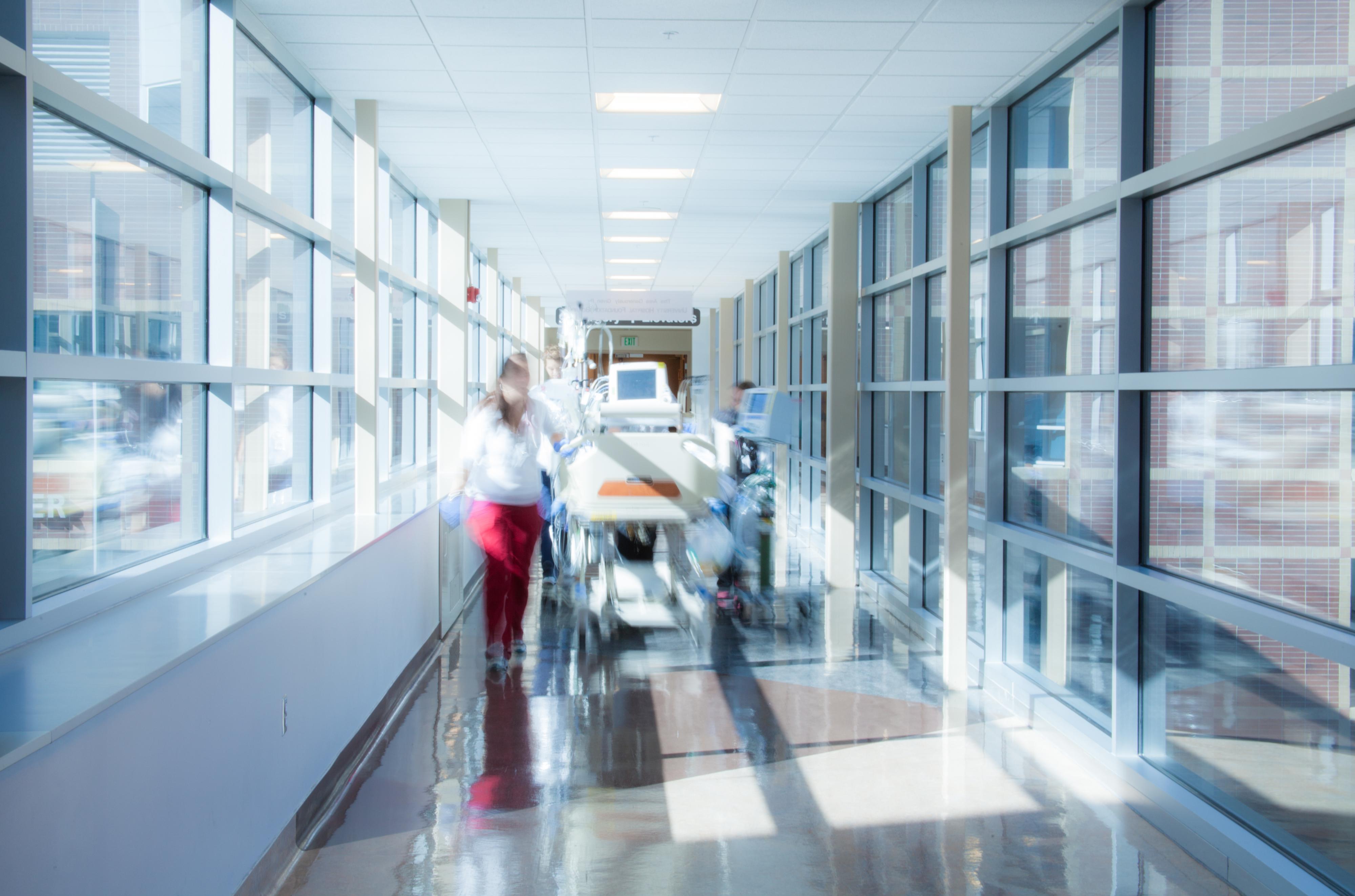 Blurry doctors in hallway with patient